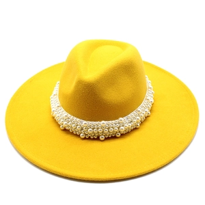 Detail view of yellow wide brim wool fedora hat featuring multi-layered pearl band decoration