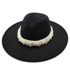Close-up of elegant wide brim wool fedora hat with premium pearl beaded band detail