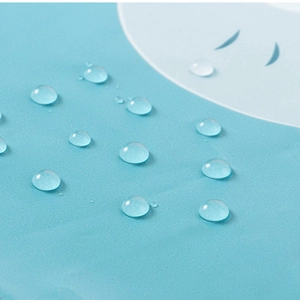 Waterproof baby apron in light blue showing clear water droplets on the surface
