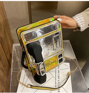 Detail view of metallic gold phone-shaped crossbody bag with laser reflective finish