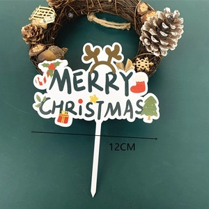 Close-up of 12cm acrylic Merry Christmas cake topper with reindeer and holiday icons