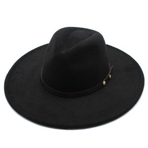 Detailed macro view of black wool felt fedora with decorative brown leather band and studs