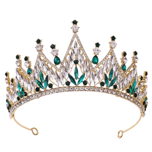 Baroque bridal crown with green crystals and gold metal frame on a white background