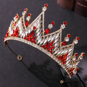 Detail of a luxury gold bridal crown with marquise red rhinestones and clear crystals