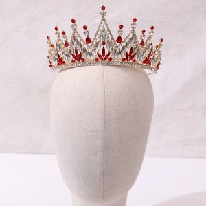 Detailed close-up of golden bridal tiara with sparkling red and white crystals