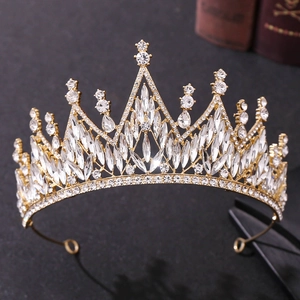 Close-up of golden bridal crown with sparkling white crystals and marquise rhinestones