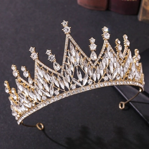 Detail of a golden bridal crown featuring brilliant white crystals on a dark background