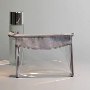 Neceser transparente de PVC con borde gris para viajes y almacenamiento de cosméticos