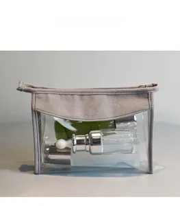 Macro view of transparent travel pouch with gray suede trim and silver zipper closure