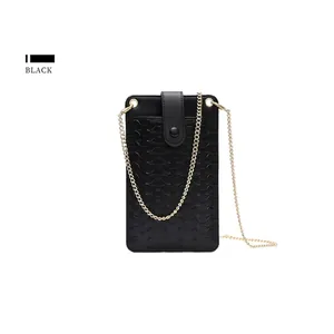 Detail of black woven texture phone bag with elegant gold chain strap and snap button