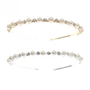 Close-up of elegant thin alloy headbands with white pearls and sparkling rhinestones
