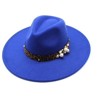 Detail of electric blue fedora with leopard print band and faux pearl flower ornaments