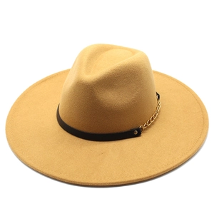 Detail of ginger wool fedora hat featuring black leather band and gold metal chain link