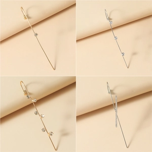Detailed close-up of linear rhinestone-inlaid ear crawlers in gold and silver finish