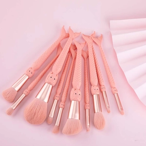 Detail of 10 pink mermaid makeup brushes with rose gold ferrules and soft synthetic bristles