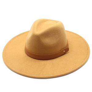 Close-up of camel wool fedora hat with wide brim and brown leather decorative band