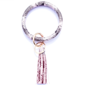 Close-up of pink and grey snake print leather keychain bangle with fringe tassel