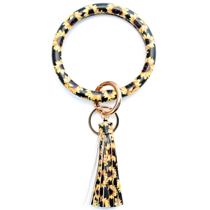 Faux leather keychain ring with sunflower print and matching tassel charm on white background