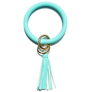 Detail of Tiffany blue leather keychain bracelet with golden clasp and long fringe tassel