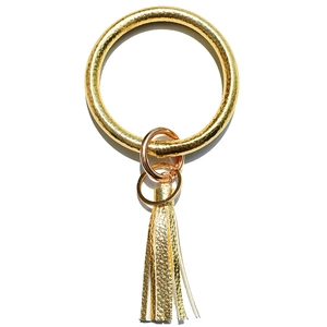 Detailed view of gold snakeskin leather keyring bracelet with fringe tassel charm