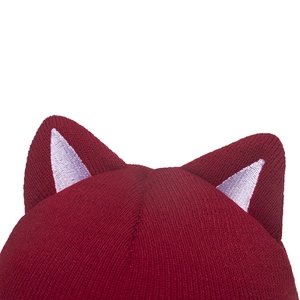 Detailed macro view of the knitted cat ears in burgundy red and grey contrasting colors