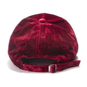 Detail view of burgundy velvet baseball cap back with adjustable silver metal buckle strap