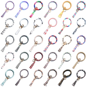 Variety of silicone O-ring keychains with tassels in leopard, snake, and floral patterns