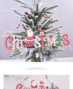 Detail of wooden CHRISTMAS lettering ornament with Santa Claus on a snowy pine tree
