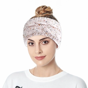 Close-up of pink knit headband with thick cable pattern and colorful fiber accents