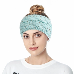 Detailed cable knit pattern on light blue winter headband with warm thick texture