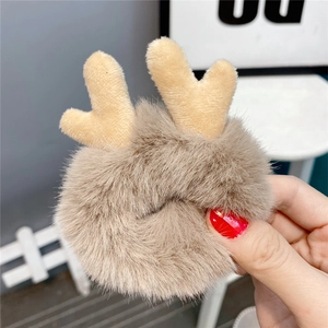 Close-up of plush reindeer antler hair tie in soft light brown and beige fleece
