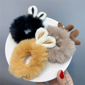 Detail of plush hair scrunchies with cute bunny ears and reindeer antlers in three colors