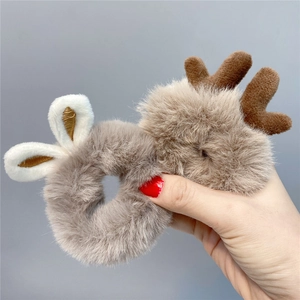 Detail of plush reindeer antlers and white bunny ears on fuzzy brown elastic hair scrunchies