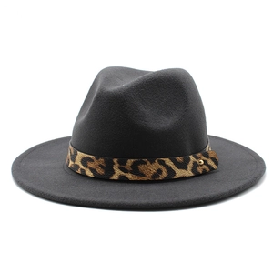 Detail of dark grey fedora with leopard print band and gold metal rivet embellishment