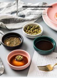 Close-up of matte ceramic dipping sauce bowls in Nordic pink, green, black and white