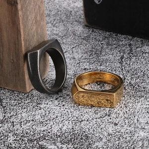 Close-up of hip-hop style men's geometric signet rings in gold and vintage silver finish