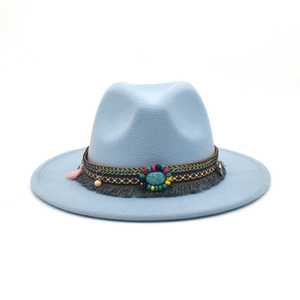 Macro view of blue wool felt fedora with colorful ethnic beadwork and grey tassel detail