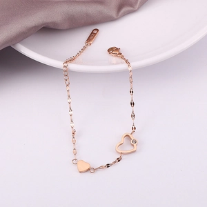 Macro shot of rose gold titanium heart bracelet showing K18 hallmark on the clasp