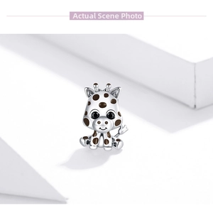 Detailed close-up of a S925 sterling silver giraffe charm with brown enamel and black crystal