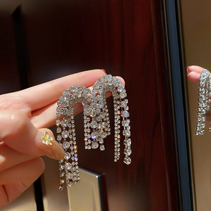 Sparkling silver fringe earrings with full rhinestones in a modern arched design