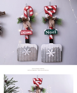 Detail of Christmas wooden spade ornament with pine cones, Noel sign and burlap bow