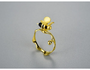 Macro detail of S925 silver bee ring featuring golden finish and black enamel accents