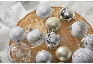 Detailed view of silver and white patterned Christmas balls in an amber glass tray