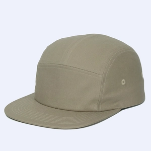 Macro shot of khaki cotton five-panel camper hat showing fine twill fabric and stitching