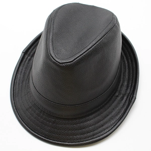 Detail shot of black faux leather fedora hat featuring distinct litchi texture and stitching
