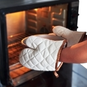 Insulated beige quilted oven mitts providing high temperature protection for baking
