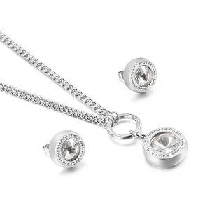 Elegant silver jewelry set with crystal pendant necklace and round stud earrings on white