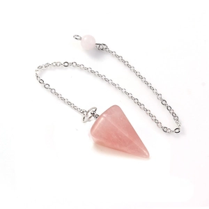 Macro detail of hexagonal rose quartz crystal pendant with a sleek silver chain