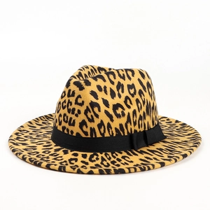 Detail of leopard print fedora hat featuring a wide flat brim and black grosgrain ribbon