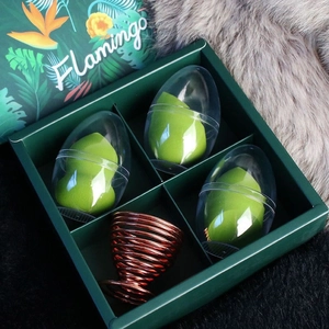 Detail of green makeup sponge set in tropical gift box with rose gold drying stand